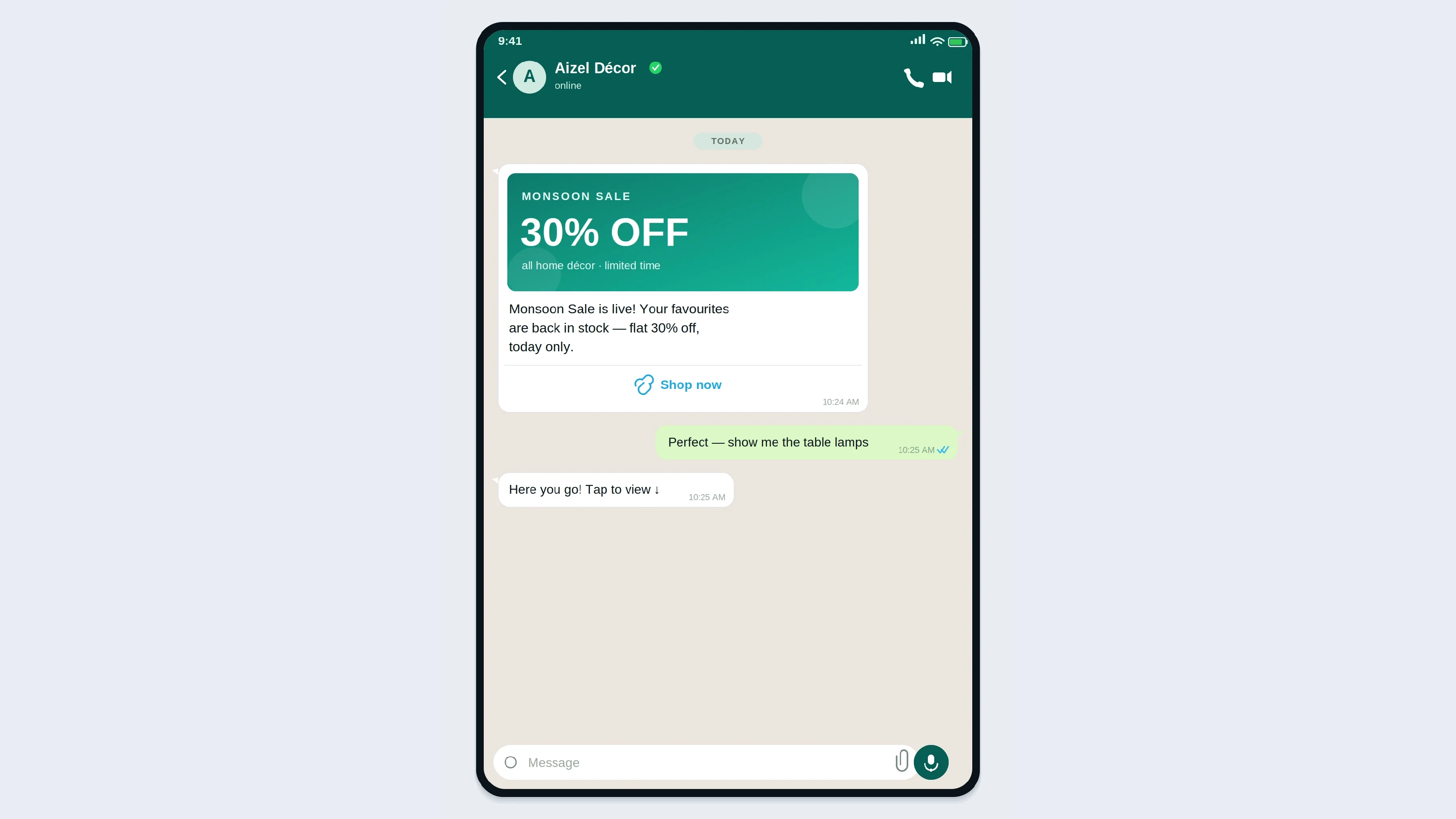Smartphone on a wooden desk displaying a friendly WhatsApp business chat with a product photo, a short greeting, and a green call-to-action button, beside a cup of chai.
