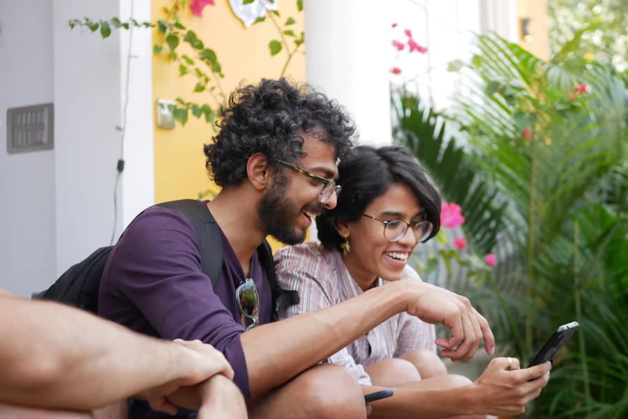 Two friends laughing at a message on a phone